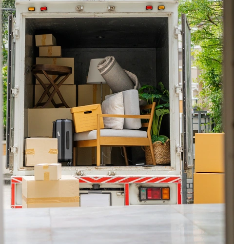 Professional movers carrying wrapped furniture safely during a residential relocation by City of Angels Move